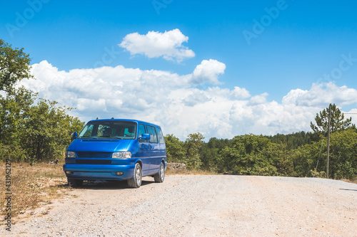 Camping adventure in the wilderness: Minivan is standing at the side of the desert road © Patrick Daxenbichler