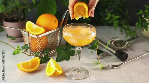 Looping Cinemagraph of woman hand squiz juce from slice orange