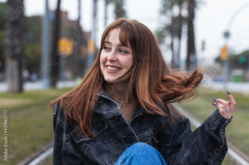 Cheerful woman with brown hair looking away