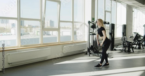 Wallpaper Mural Young active sporty blonde girl trains in the gym. Athletic professional female fitness trainer prepares for work out rolling out training mat. Slow motion wide angle shot on cinema camera in 4K. Torontodigital.ca