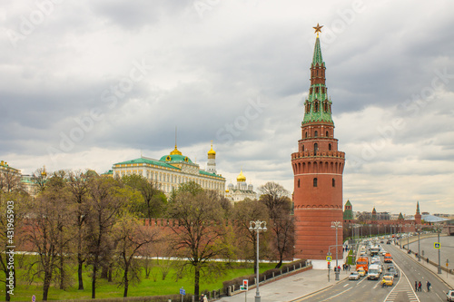 Fototapeta Naklejka Na Ścianę i Meble -  panoramic view of the Moskva River and the Kremlin embankment with a red brick wall, water tower, the Grand Kremlin Palace and the bell tower of Ivan the Great against the in Moscow Russia