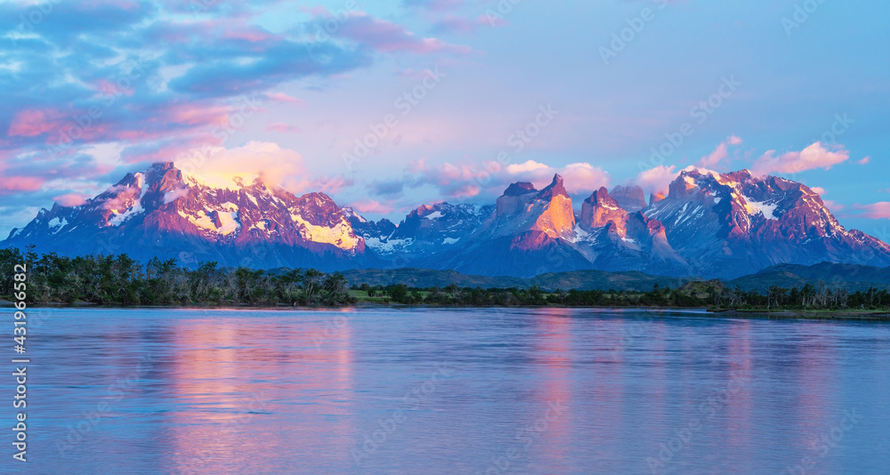 Panorama sunrise of the Serrano river with the Andes peaks of Torres del Paine, Patagonia, Chile.