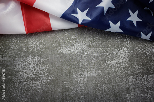 Flat lay, top view United States of America flag is on top of dark gray stone background with copy space. Close up. USA Memorial day concept.