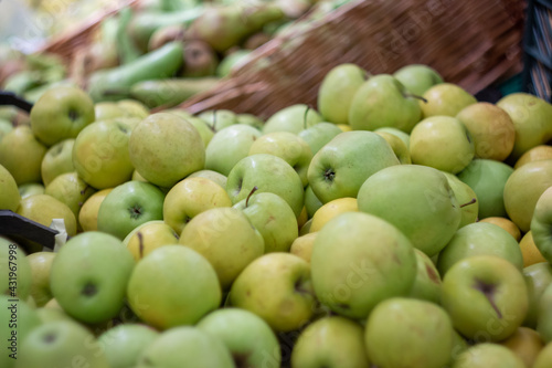 Boxes of juicy apples in the supermarket. Photo on the theme of fruit.