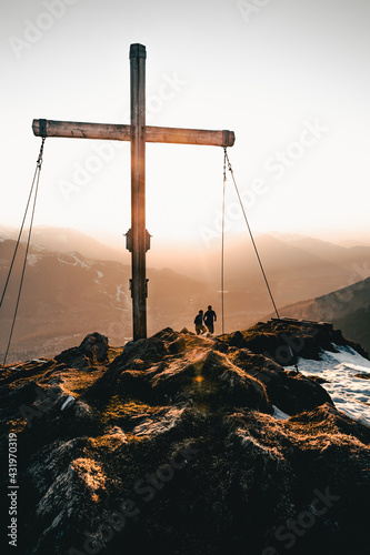 Two athletes running to mountain top