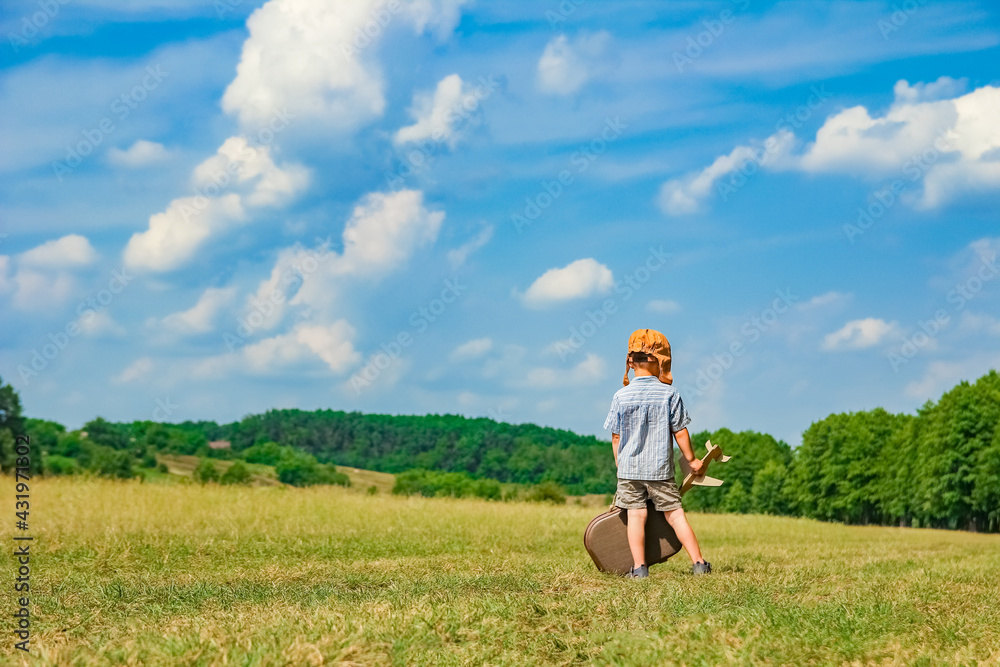 A Baby boy by the plane plays on nature in the park. Boy on vacation pilot. A Baby boy by the plane plays on nature in the park. Boy on vacation pilot.
