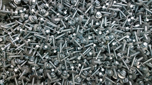 Background or texture of roofing screws with drill and rubber washer