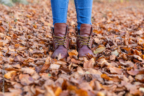 Wallpaper Mural Woman in boots standing in autumn leaves while hiking in forest Torontodigital.ca