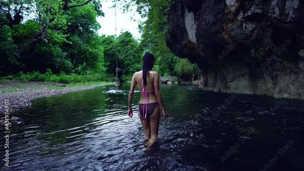 Cute Asian Girl walking in Bikini in the River, Thailand.