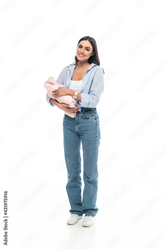 full length view of young woman with newborn child smiling at camera on white background. full length view of young woman with newborn child smiling at camera on white background.