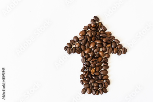 coffee trend. coffee beans on a white background in the shape of an arrow. coffee direction.