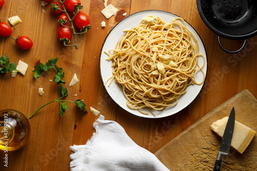 Plate filled with spaghetti on wooden table photo