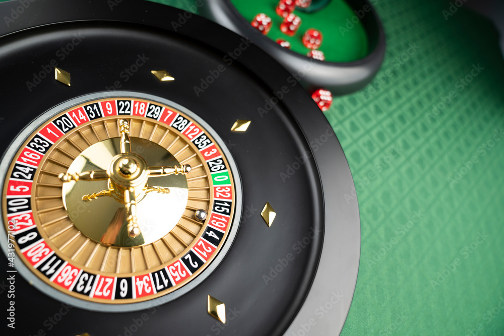 Casino theme. Roulette wheel on green table. Casino theme. Roulette wheel on green table.