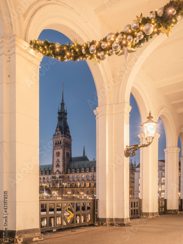 Germany, Hamburg, Alster arcades with Christmas decorations and view of town hall at dawn photo