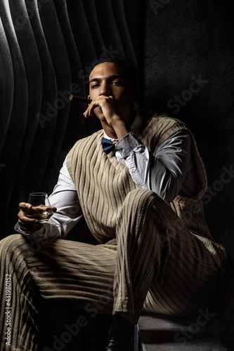 Portrait of a serious young black man smoking a cigar
