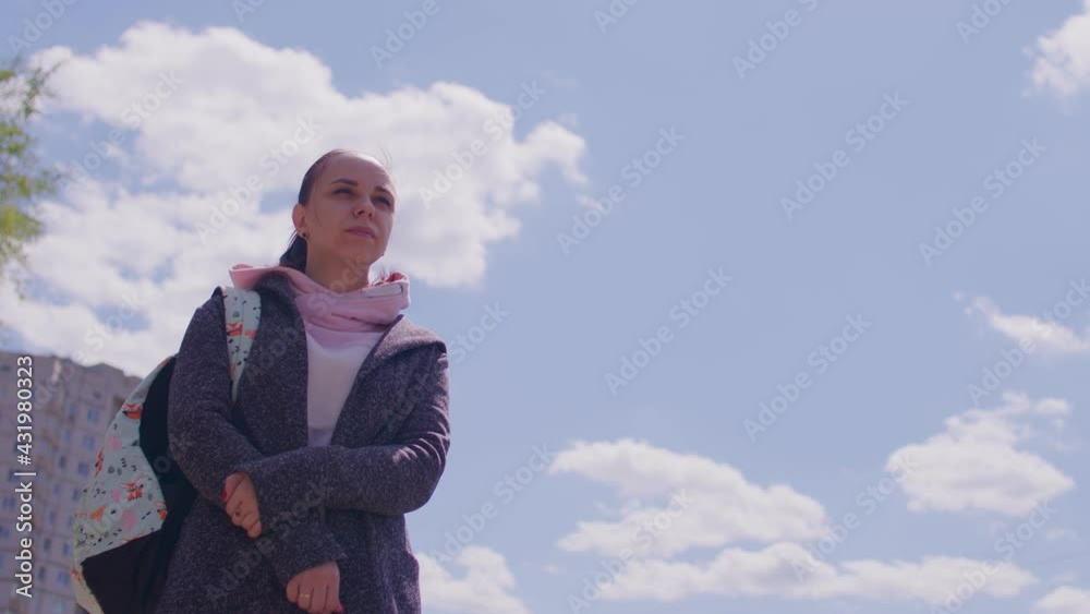 Close up of young woman on street in sunny weather. Portrait of female in casual clothing with backpack standing on fresh air. Close up of young woman on street in sunny weather. Portrait of female in casual clothing with backpack standing on fresh air.