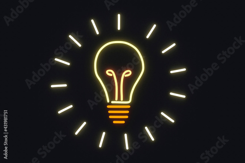Illuminated light bulb on black wall