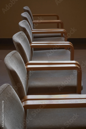 Row of wooden upholstered chairs.