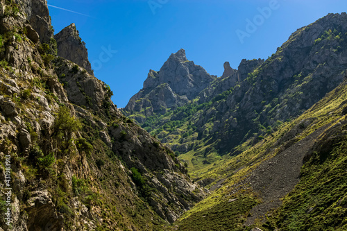 Inside a deep valley with views of the spectacular mountains that surround it. Photograph taken in the Picos de Europa, Asturias, Spain. 