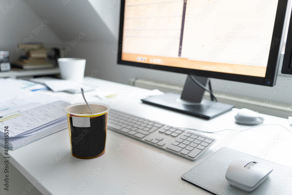Computer with cup and diary on desk at home office Computer with cup and diary on desk at home office