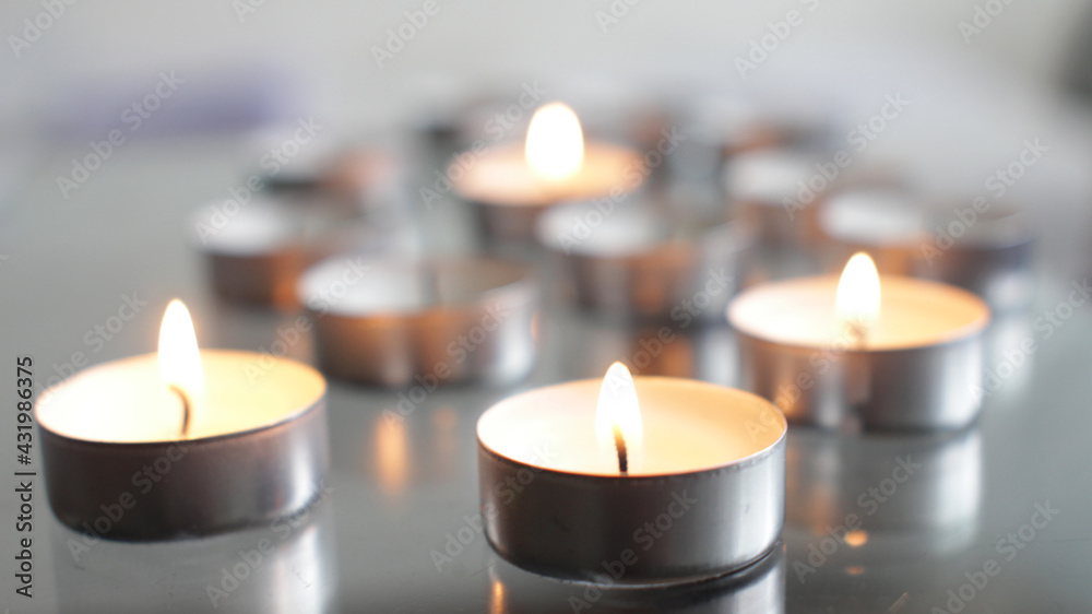 Tea Candles Burning on Transparent Table at Daylight Tea Candles Burning on Transparent Table at Daylight