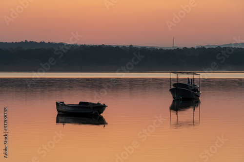 Boats on the lake at sunrise. Tranquil nature scene landscape