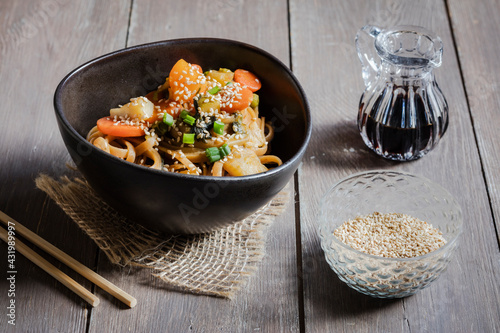 Bowl of vegan pasta with vegetables and sesame seeds photo