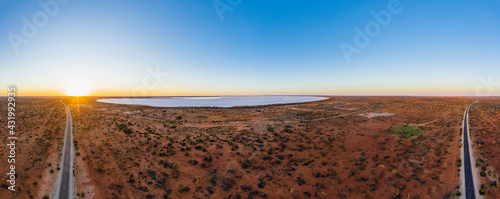 Australia, South Australia, Aerial view of Stuart Highway and salt lake in Lake Hart Area at sunset photo