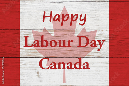 Happy Labour Day Canada message with Canadian maple leaf flag on wood