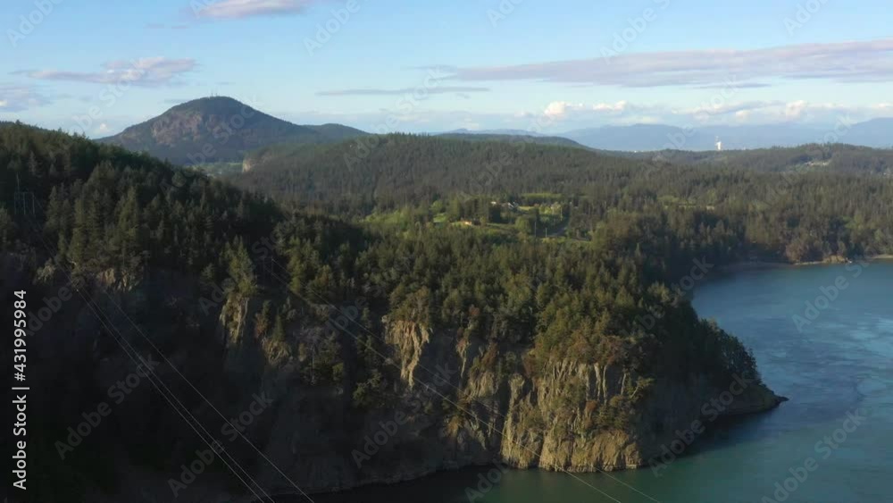 Rising Up Over Deception Pass for a View of Hills, Forest, Mountains, and Sky Rising Up Over Deception Pass for a View of Hills, Forest, Mountains, and Sky