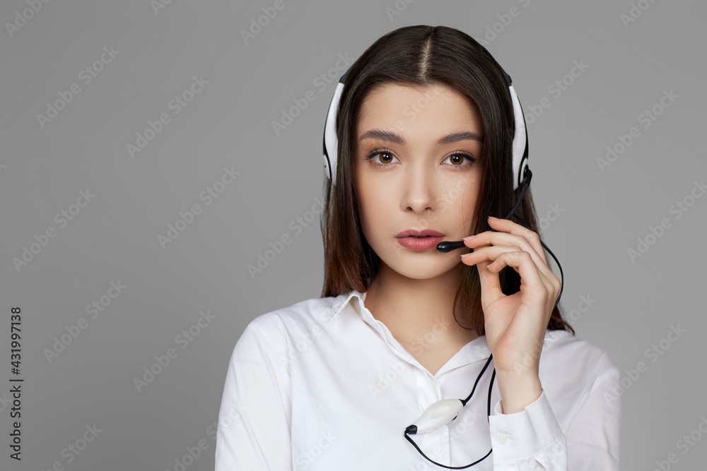 caucasian woman with headset on gray background caucasian woman with headset on gray background