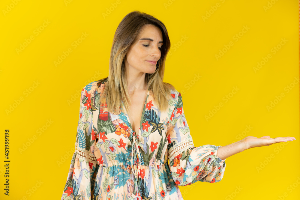 Young caucasian woman posing isolated holding something with a hand, product presentation. Young caucasian woman posing isolated holding something with a hand, product presentation.