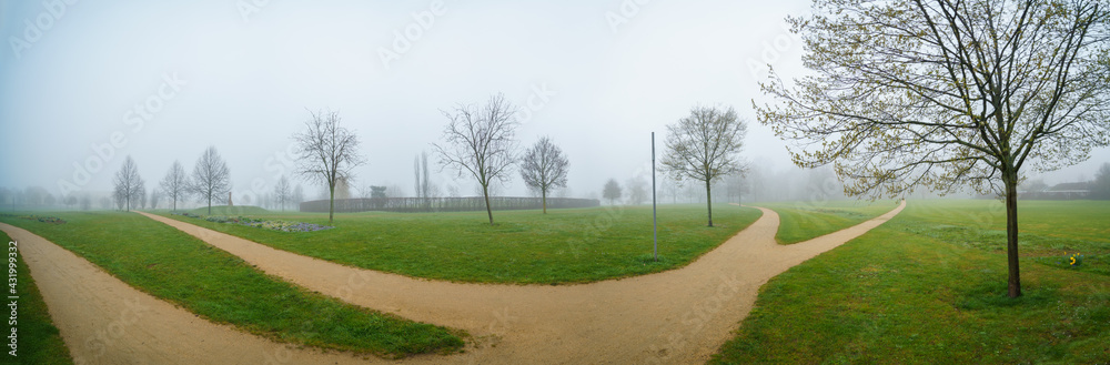 Panorama of the city park with green lawns