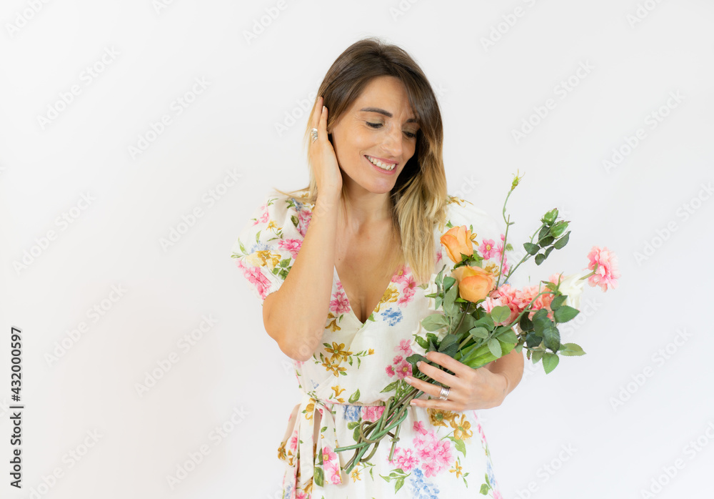 Smiling woman in summer dress holding bouquet of flowers isolated over white background. Smiling woman in summer dress holding bouquet of flowers isolated over white background.