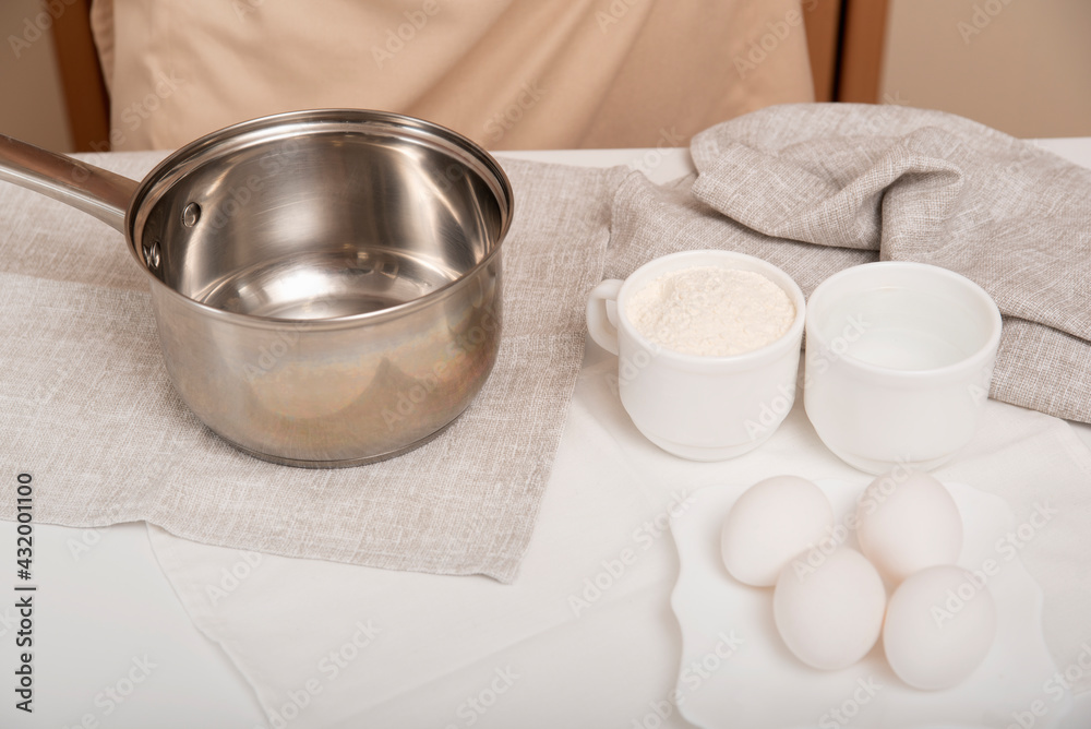 Dough preparation process. Kitchen utensils and products on the table. Dough preparation process. Kitchen utensils and products on the table.