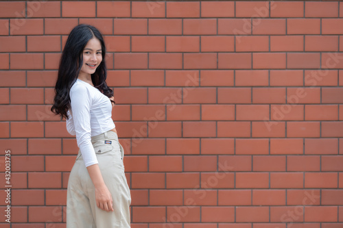 Portrait of hipster girl  on brick wall background,Beautiful asian woman pose for take a photo,Kawaii style © reewungjunerr