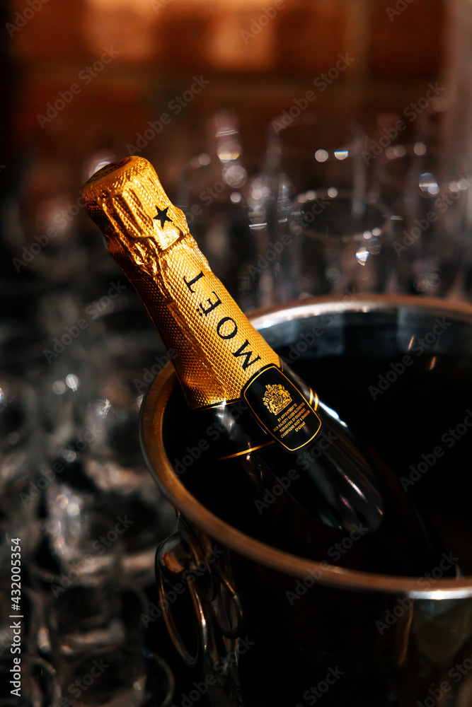 PERM, RUSSIA SEPTEMBER 5, 2020: bottle of brut sparkling wine Moet and  Chandon imperial in an ice bucket on the wine table. Glass glasses behind.  Stock Photo | Adobe Stock
