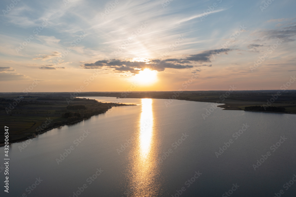 Aerial view of a still lake at sunset