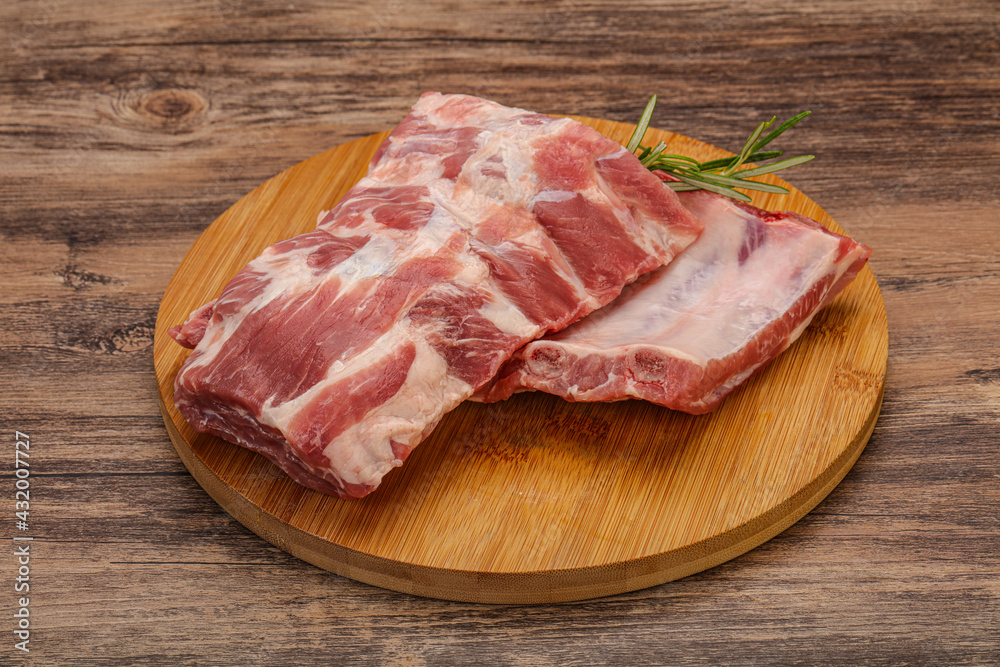 Raw pork ribs served rosemary