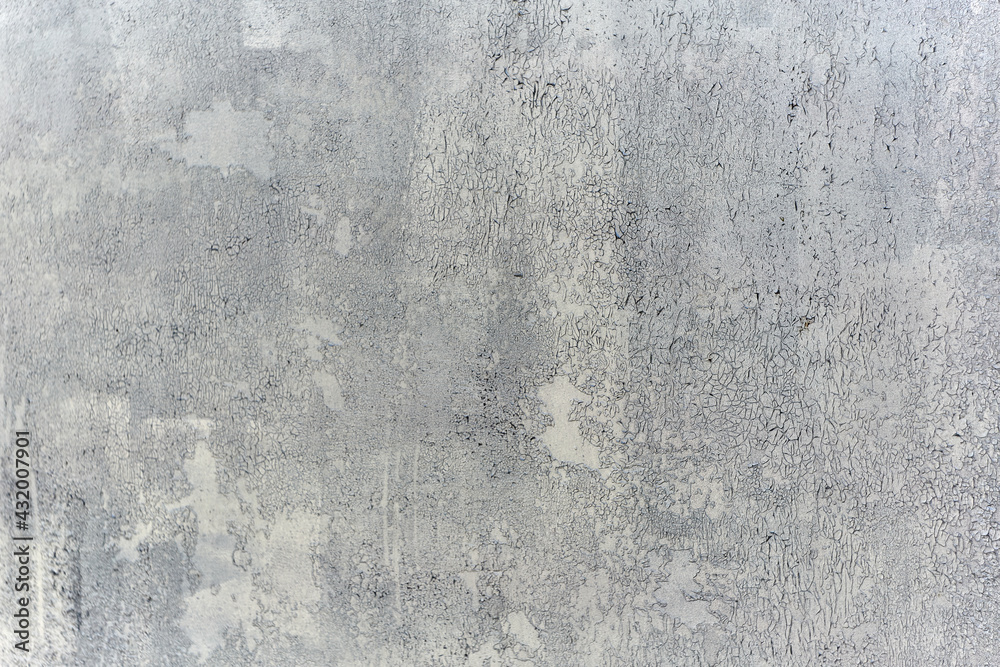 Texture of a wall made of rough metal painted with gray cracked paint