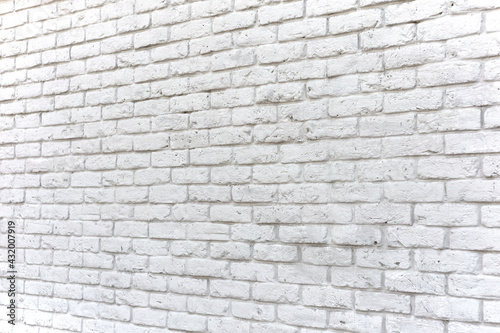 Wall texture of damaged pure white brick, perspective view