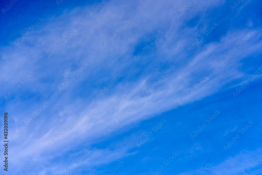 background of clouds of feather clouds on a blue sky.
