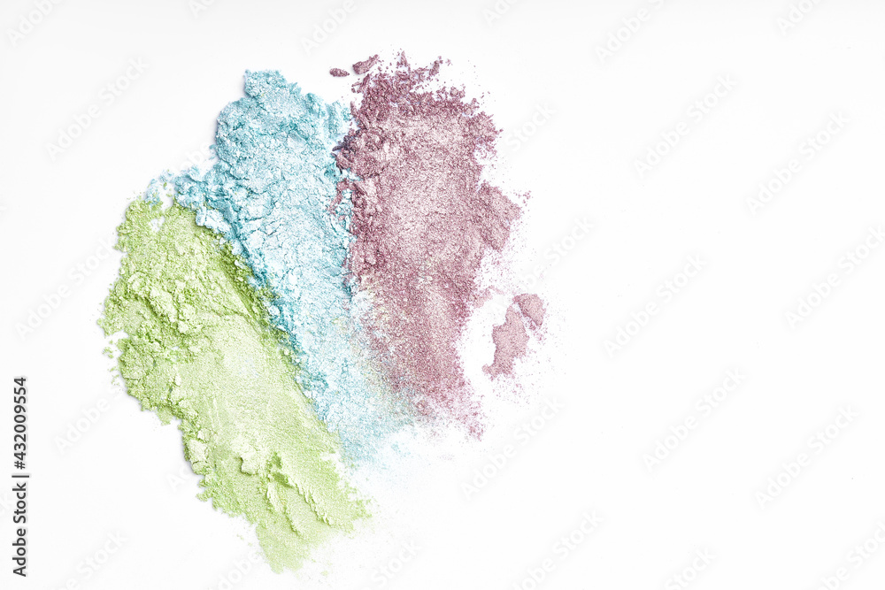 Fototapeta premium Flat lay of brush strokes. Broken shiny bright eyeshadow as samples of cosmetic beauty products. Eyeshadow swatches
