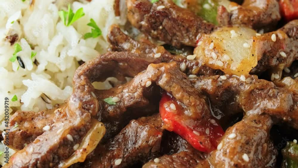 Stir fry Chinese pepper beef steak with onion, red and green bell pepper, basmati, wild rice Stir fry Chinese pepper beef steak with onion, red and green bell pepper, basmati, wild rice