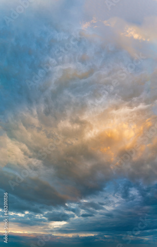 Fantastic clouds at sunrise  vertical panorama