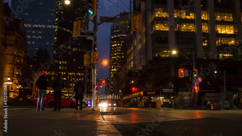 night traffic in the city Toronto downtown. Pedestrians, cars and street lights