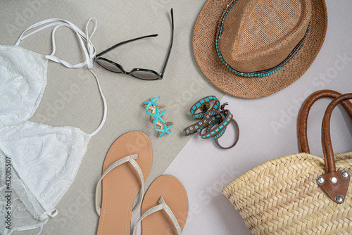 Fashion set of summer clothes and accessories for woman. Beach outfit with sunnglasses,flip flops,jewelry, bags, hat and swimsuits.Top view.Holiday concept.