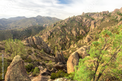 Landscape of the conglomerate stone and rolling hills from which it juts out in Pinnacles National Park, CA
