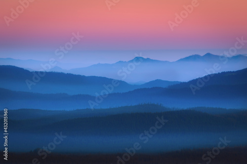 The glowing mist in the predawn hour over the distant Cascade range in Oregon. photo