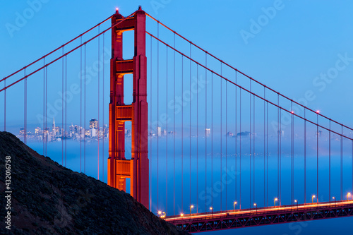 With the San Francisco Bay full of beautiful low lying fog, the commuting traffic glows across the Golden Gate Bridge. photo